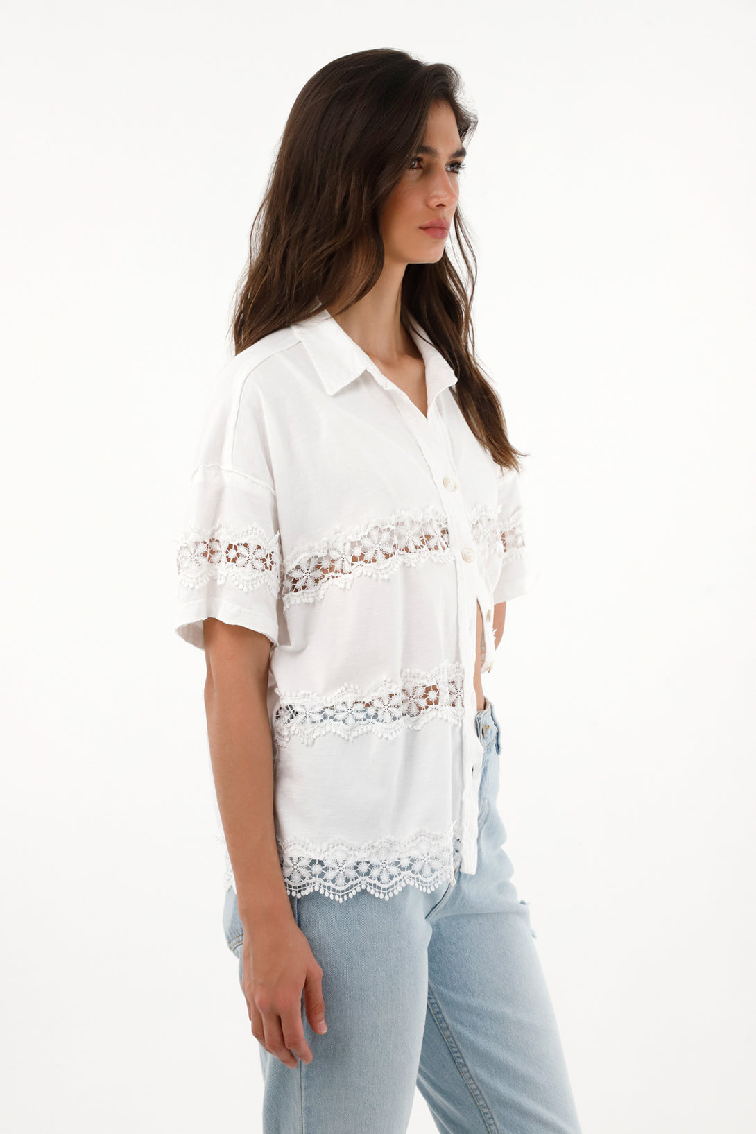 Women's short sleeve shirt with decorative cutouts.