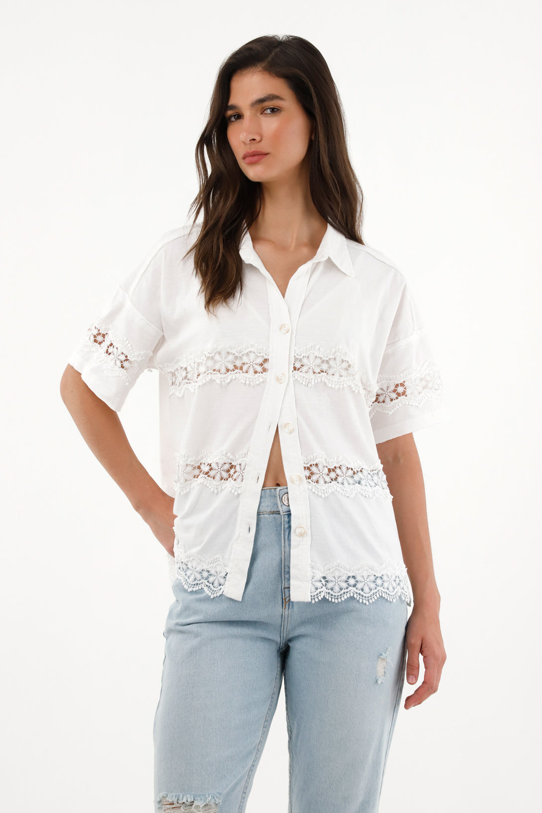 Women's short sleeve shirt with decorative cutouts.