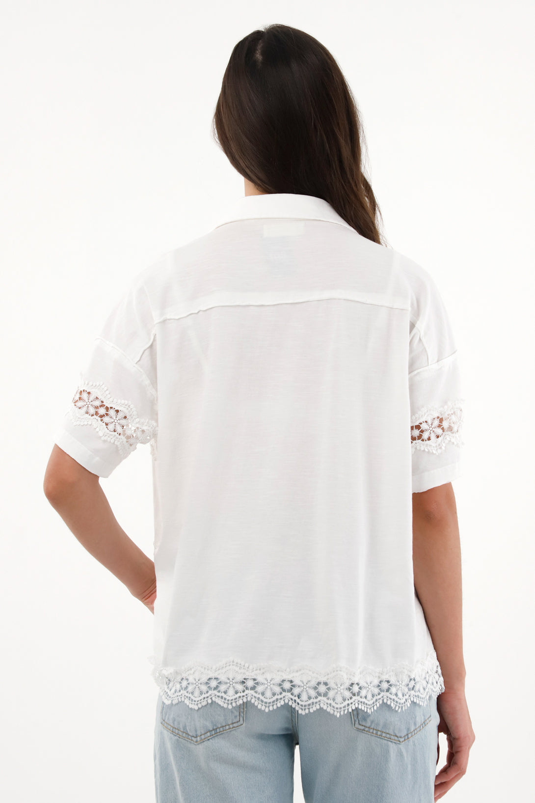 Women's short sleeve shirt with decorative cutouts.