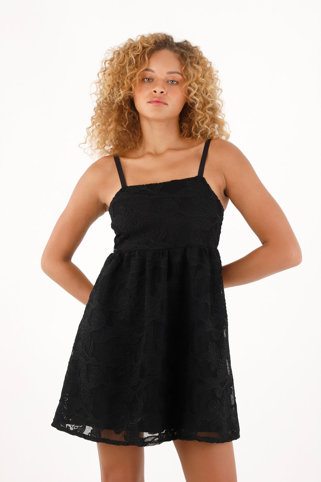 Women's short black dress in embroidered fabric.